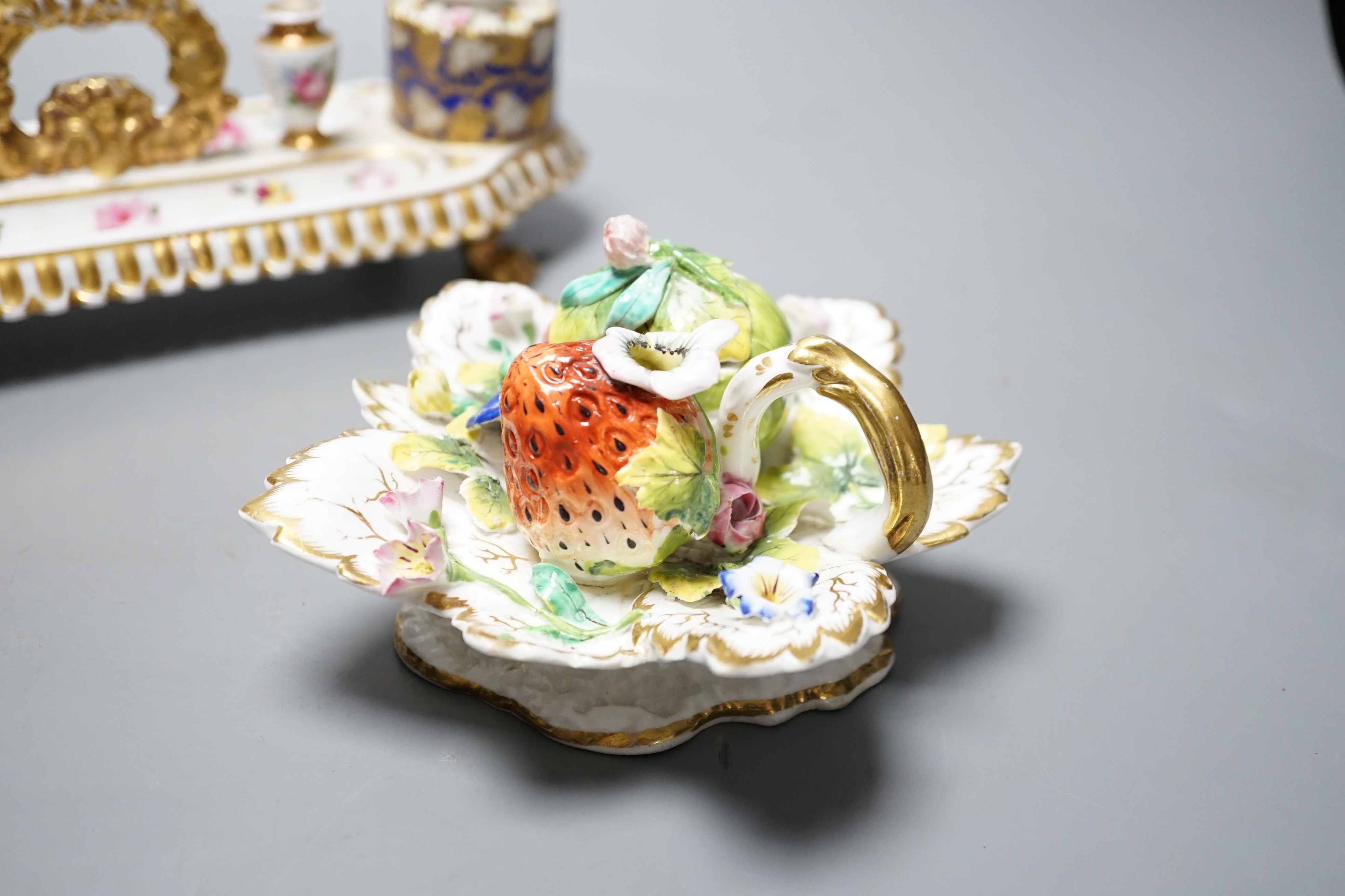 A 19th century Chamberlain Worcester inkstand painted with roses and heatsease, script mark, and a 19th century English porcelain leaf shaped inkwell with strawberry shaped wells, encrusted with flowers picked out in gil